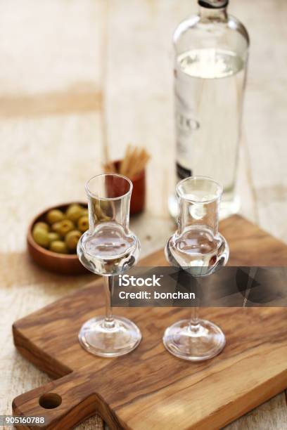 Two Glasses Of Grappa Bianca Italian Digestif Grapebased Pomace Brandy Stock Photo - Download Image Now