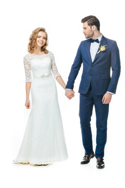 istock beautiful groom and bride holding hands isolated on white 905160860