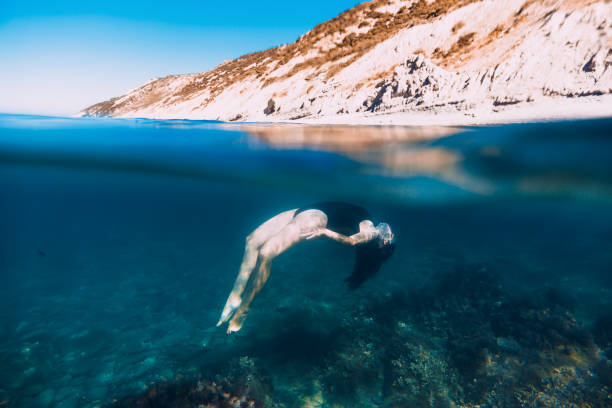 istock Active young woman in bikini relax underwater in ocean, dive underwater 905163528