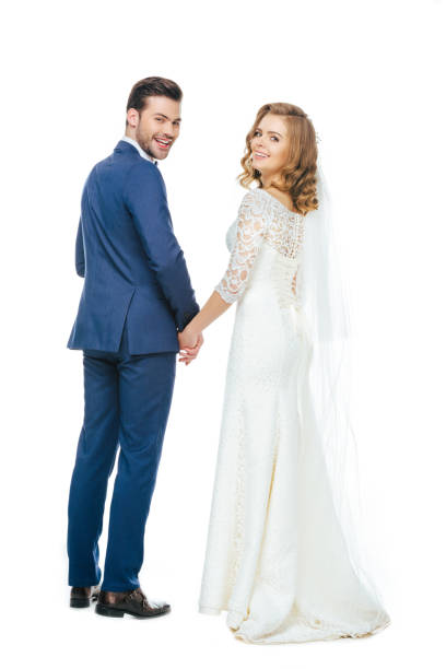 istock back view of beautiful wedding couple holding hands 905168058