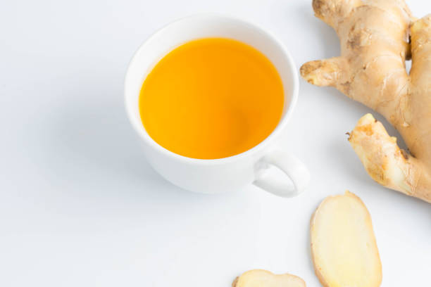 istock hot ginger tea ginger ale ginger beer in glass with ginger slice on white background 905168136
