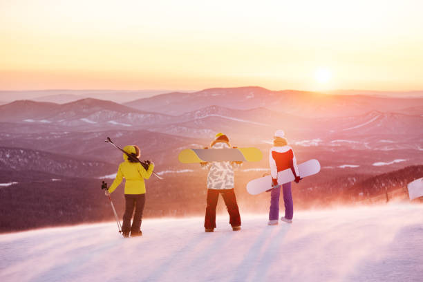 Skiers sitting on the express lift and skiing on the snow ground in Aspen Snowmass Ski Resort in Colorado