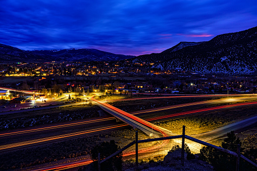 Gypsum Colorado with I-70 Interstate Highway at Dusk - Lights and vehicles with town lit up during blue hour dusk. Eagle/Vail Valley, Colorado USA
