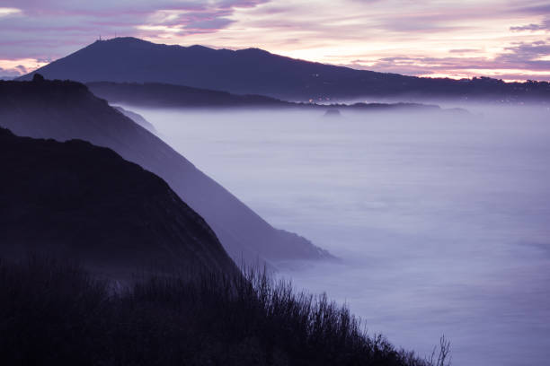 istock panoramic landscape view after sunset on atlantic coastline in pink sky with huge waves, basque country, france 905173240
