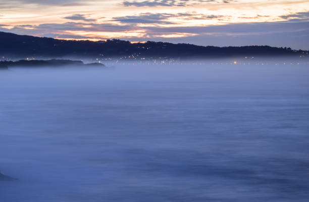 istock panoramic landscape view after sunset on atlantic coastline in twilight with huge waves, basque country, france 905175858