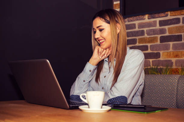 istock Woman using laptop in cafe 905176450