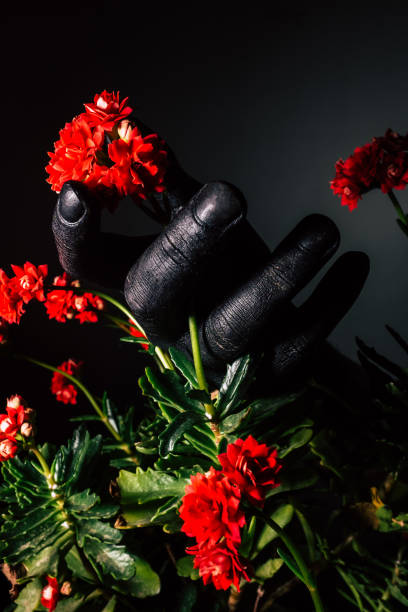 Black hand holding colorful spring flowers