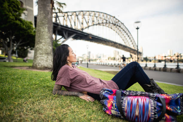 istock Woman relaxing next to Sydney Harbor Bridge 905177150