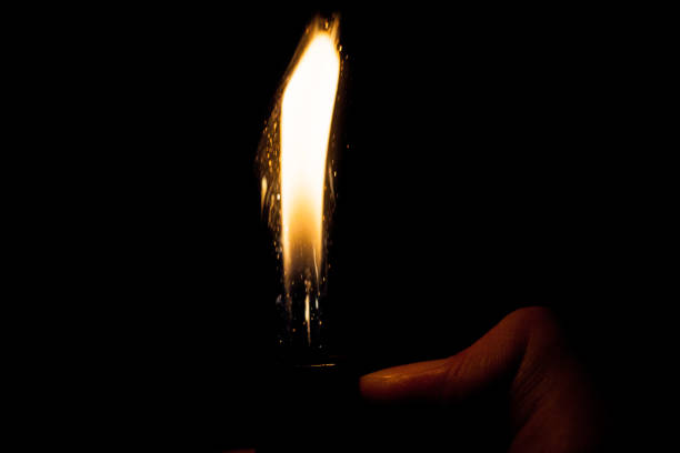 istock Close up view of real sparking light from lighter in dark black background 905179704