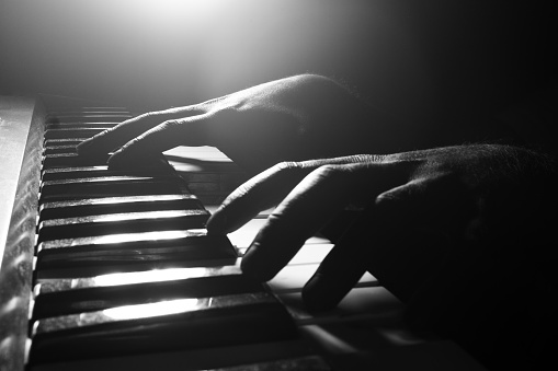 Hands playing piano close-up