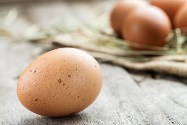istock fresh brown chicken egg on a wooden background 905185602