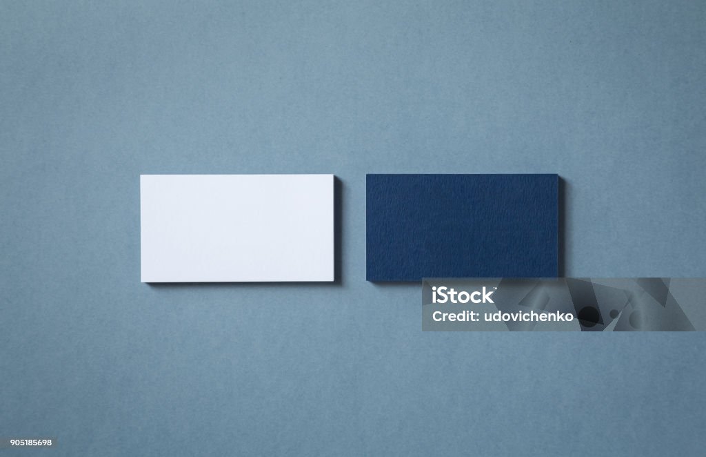 Blank business cards Thick blank double-sided business cards with textured surface stacked up on a grey background Business Card Stock Photo