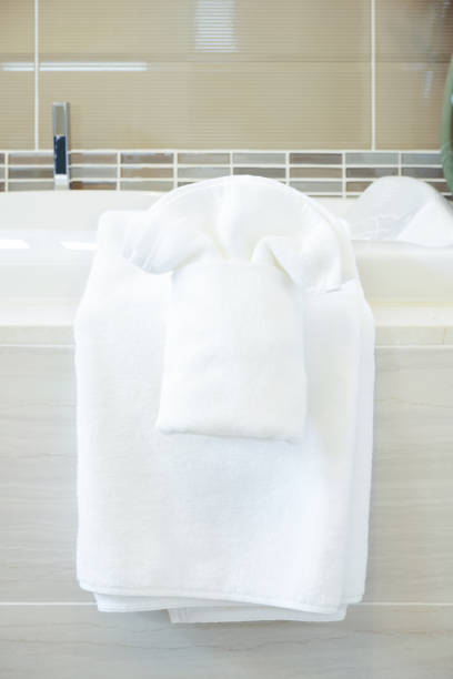 istock Closeup white towels on bathtub in modern style interior bathroom 905185922