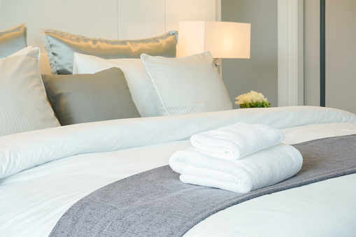 Toallas limpias en la cama en habitación de hotel photo
