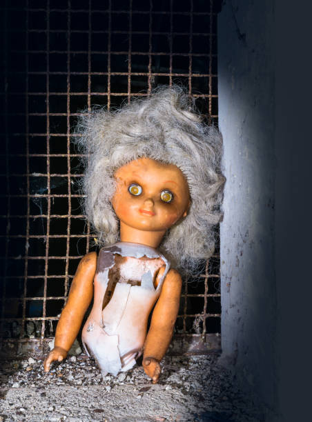 istock Broken deserted doll lit by mystery light 905188314