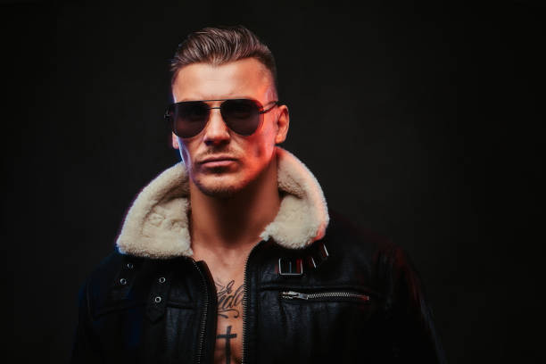 istock A macho stylish man on a dark background. 905188594