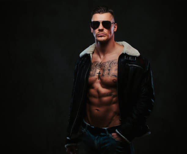 istock A macho stylish man on a dark background. 905189006