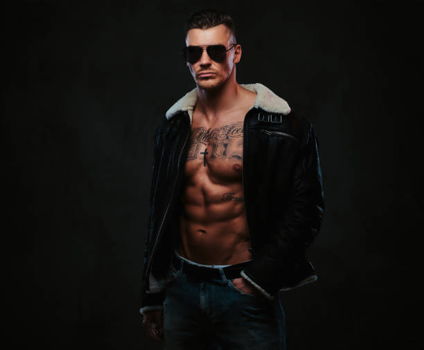 istock A macho stylish man on a dark background. 905189114