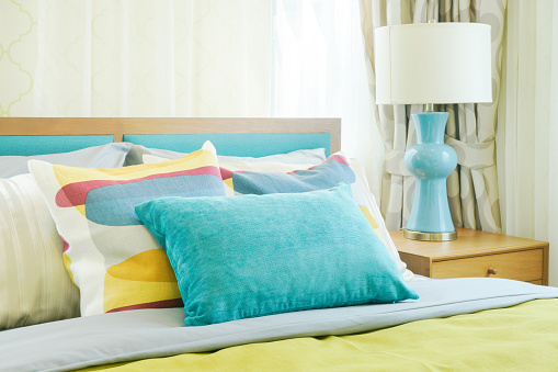 Closeup pillows on bed, yellow and green color scheme bedding