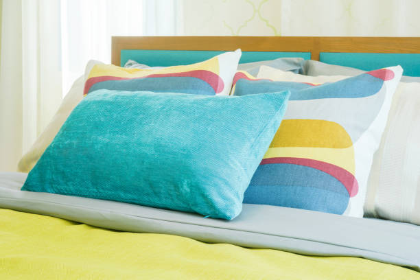 istock Closeup pillows on bed, yellow and green color scheme bedding 905192574