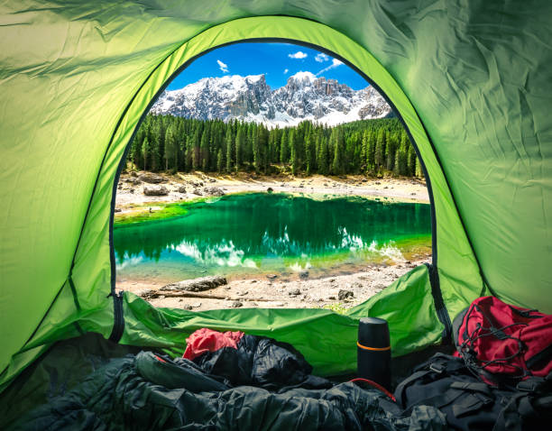 View from tent in mountain Carezza lake, Alps, Italy, Europe View from tent in mountain Carezza lake, Alps, Italy, Europe dolomites photos stock pictures, royalty-free photos & images