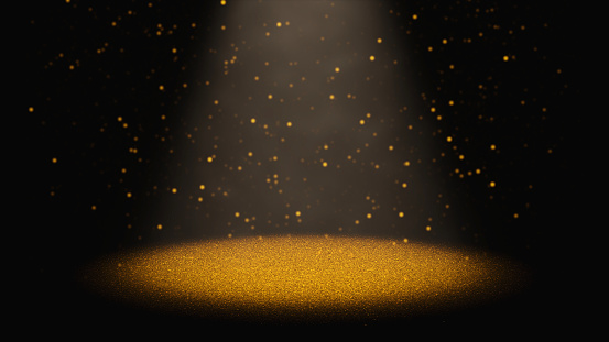 centelleo brillo oro cayendo a través de un cono de luz sobre una etapa photo