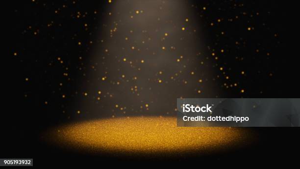 Twinkling Golden Glitter Falling Through A Cone Of Light On A Stage Stock Photo - Download Image Now