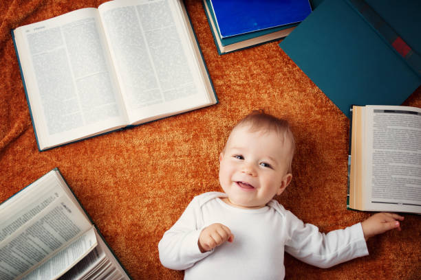 istock One year old baby with spectackles and books 905194818