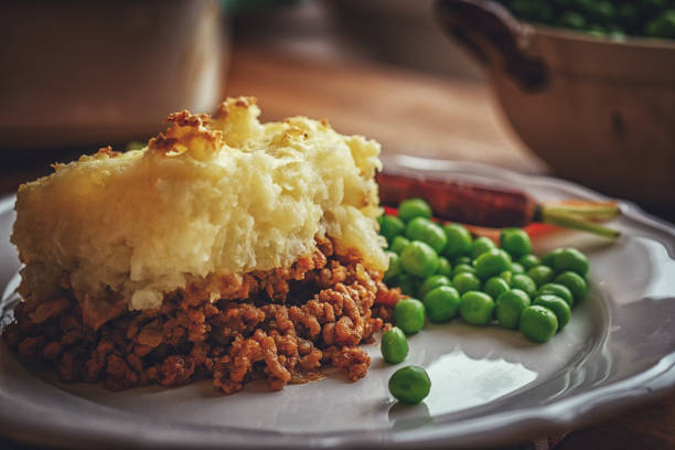 Traditional British Shepard`s Pie Traditional British Shepard`s Pie with minced meat and vegetables shepherd stock pictures, royalty-free photos & images