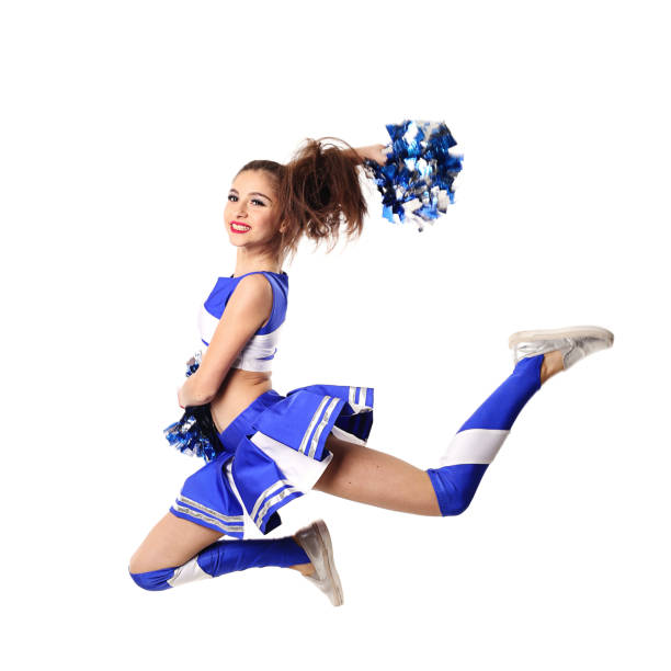 istock Young cheerleader in blue and white suit with pompoms on white background. 905197668