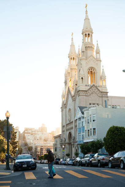 San Francisco, CA, USA - May 07, 2017: The man crossing the street close to St Peter and Paul Cathedral.
