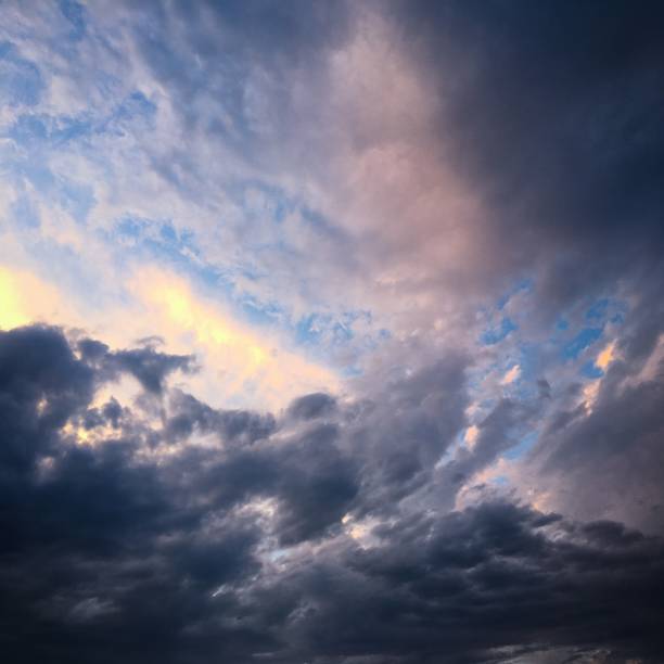 istock Beautiful stormy sky with clouds background. Dark sky with clouds weather nature cloud storm. Dark sky with clouds and sun. 905212310