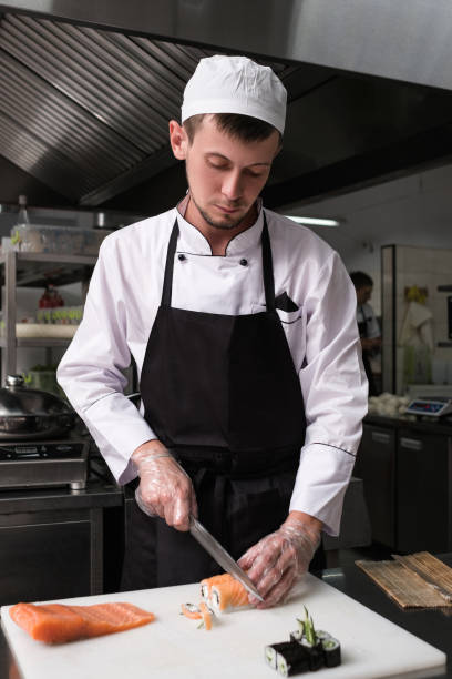 istock chef cutting sushi rolls asian cuisine 905212830
