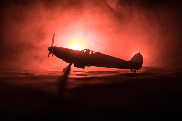istock British jet-propelled model plane in possession. Dark orange fire background. War scene. 905213804
