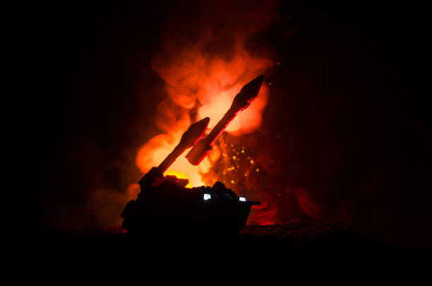 istock Rocket launch with fire clouds. Battle scene with rocket Missiles with Warhead Aimed at Gloomy Sky at night. Rocket vehicle on War Backgound. 905214036