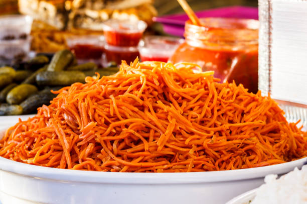 Oranges marinated carrots in a large white plate. close-up.