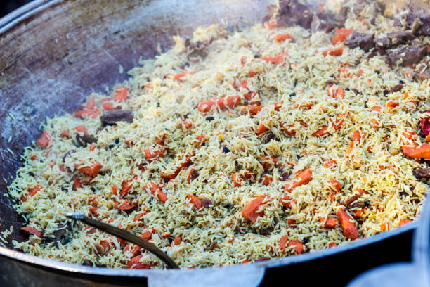 istock Fresh appetizing pilaf. Cooked with fried lamb, rice, garlic, carrots in a large caviar. 905217804