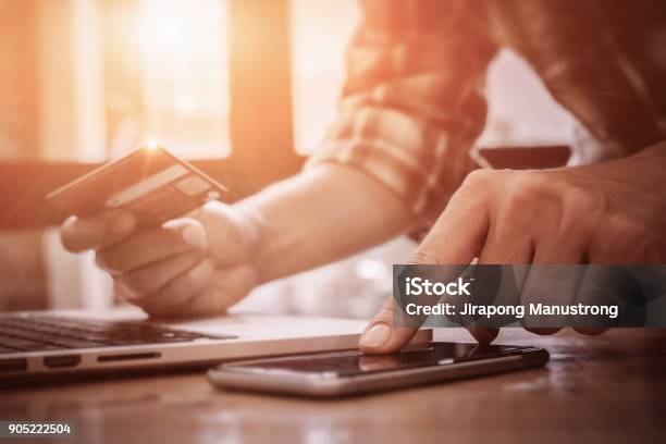 Online Paymentmans Hands Pointing Smartphone And Using Credit Card For Online Shopping Stock Photo - Download Image Now