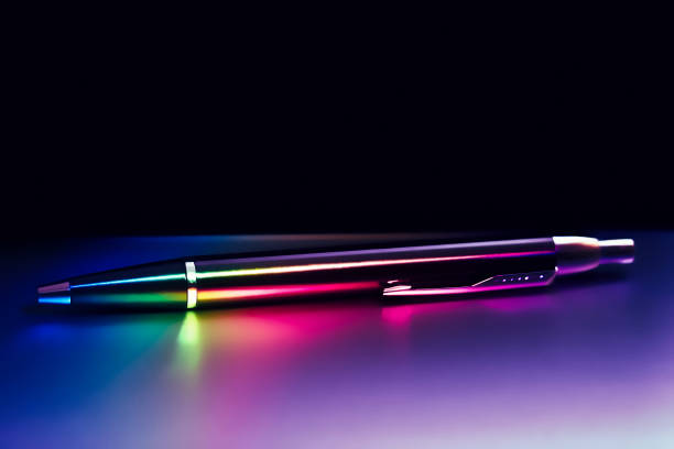 istock Ball pen illuminated with color rainbow light on matt surface 905226200