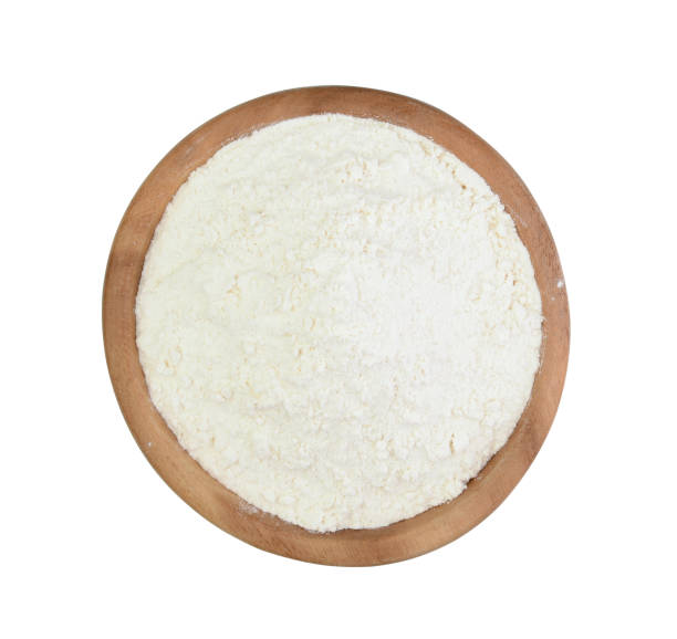 istock Wheat flour in a wooden cup isolated 905228908