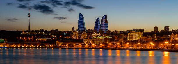 Night view of Baku with the Flame Towers skyscrapers Baku, Azerbaijan - February 23, 2017: Night view of Baku with the Flame Towers skyscrapers, television tower and the seaside of the Caspian sea baku stock pictures, royalty-free photos & images