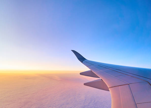 istock Flying above the clouds. Sunrise view from the airplane window. Wing 905229960
