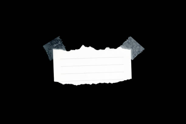 istock Pieces of notepaper isolated on black background 905230888