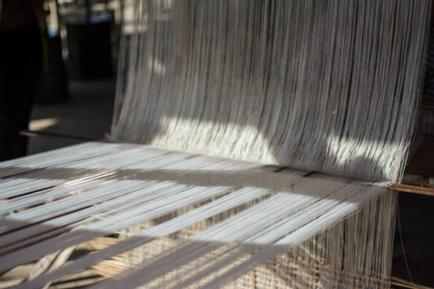 istock weaving silk in traditional way at manual loom. Thailand 905234082
