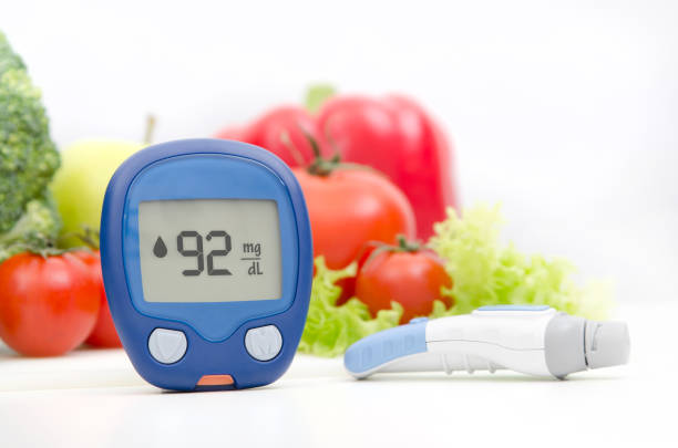 Glucometer and lancelet on vegetables background Glucometer and lancelet on vegetables background blood sugar CONTROL stock pictures, royalty-free photos & images