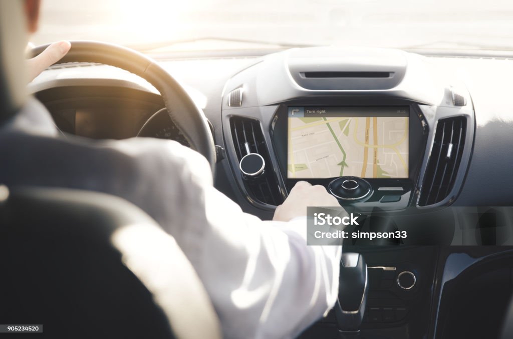 Person driving a car with GPS navigation GPS navigation system. Person driving a car with satellite navigation. Car Stock Photo