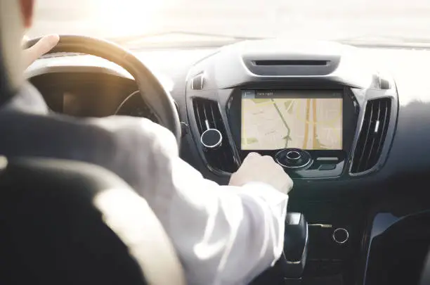 Photo of Person driving a car with GPS navigation