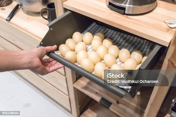 Hand Pulling Metal Kitchen Drawer Filled With Fake Eggs For Display Detail Of Furniture For Home Organizer Stock Photo - Download Image Now