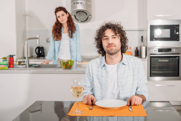 istock boyfriend waiting for food and looking at camera 905240816