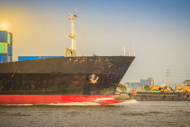 istock Massive container ship for import export and business logistic. Big cargo ship is leaving from Bangkok Port Authority of Thailand or Klong Toey port along Chao Phraya river in Bangkok,Thailand. 905240850